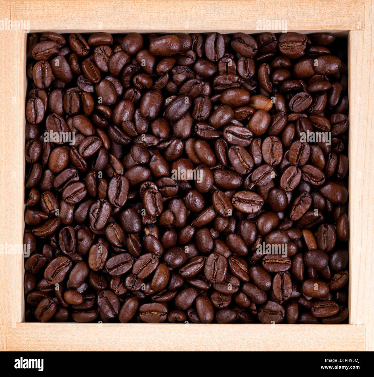 Freshly roasted coffee beans in wooden box frame Stock Photo