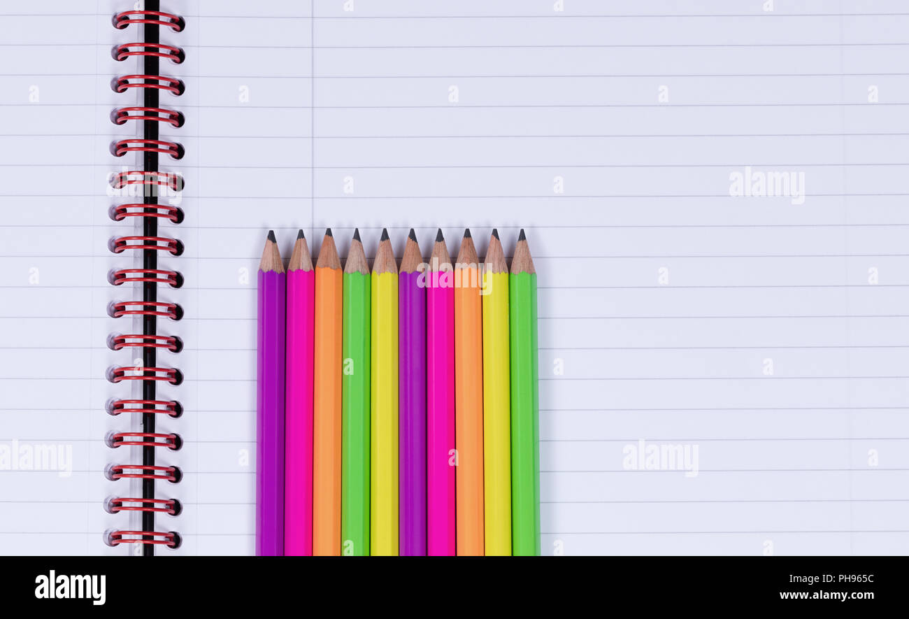 Lined up pencil tips on a spiral notebook background Stock Photo