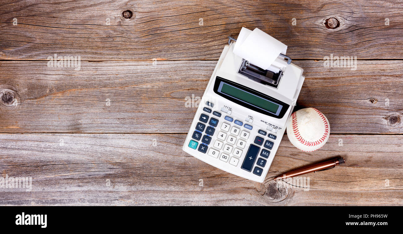 Old desktop with used business objects and worn baseball Stock Photo