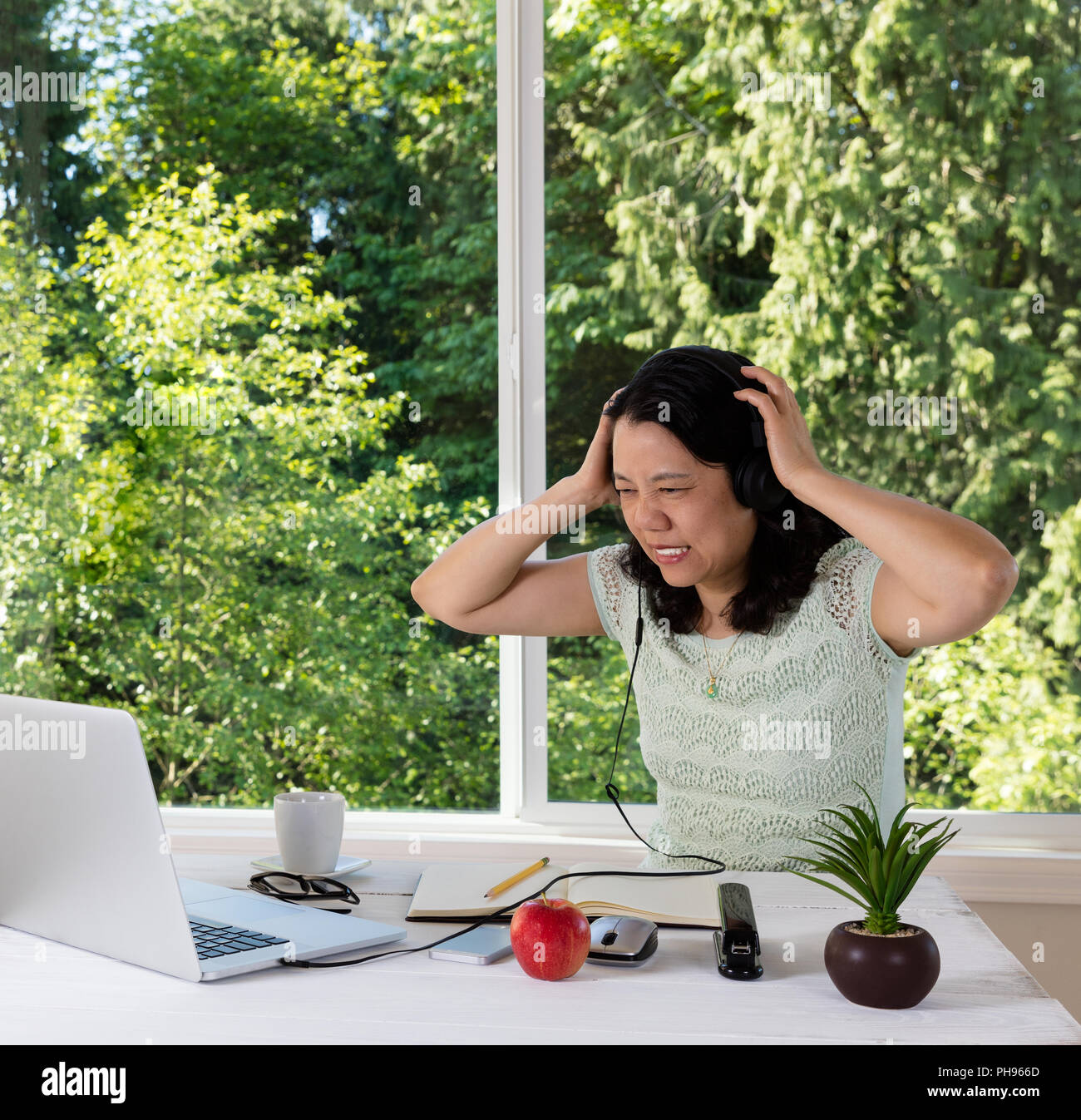 Mature woman in anger will working from home Stock Photo