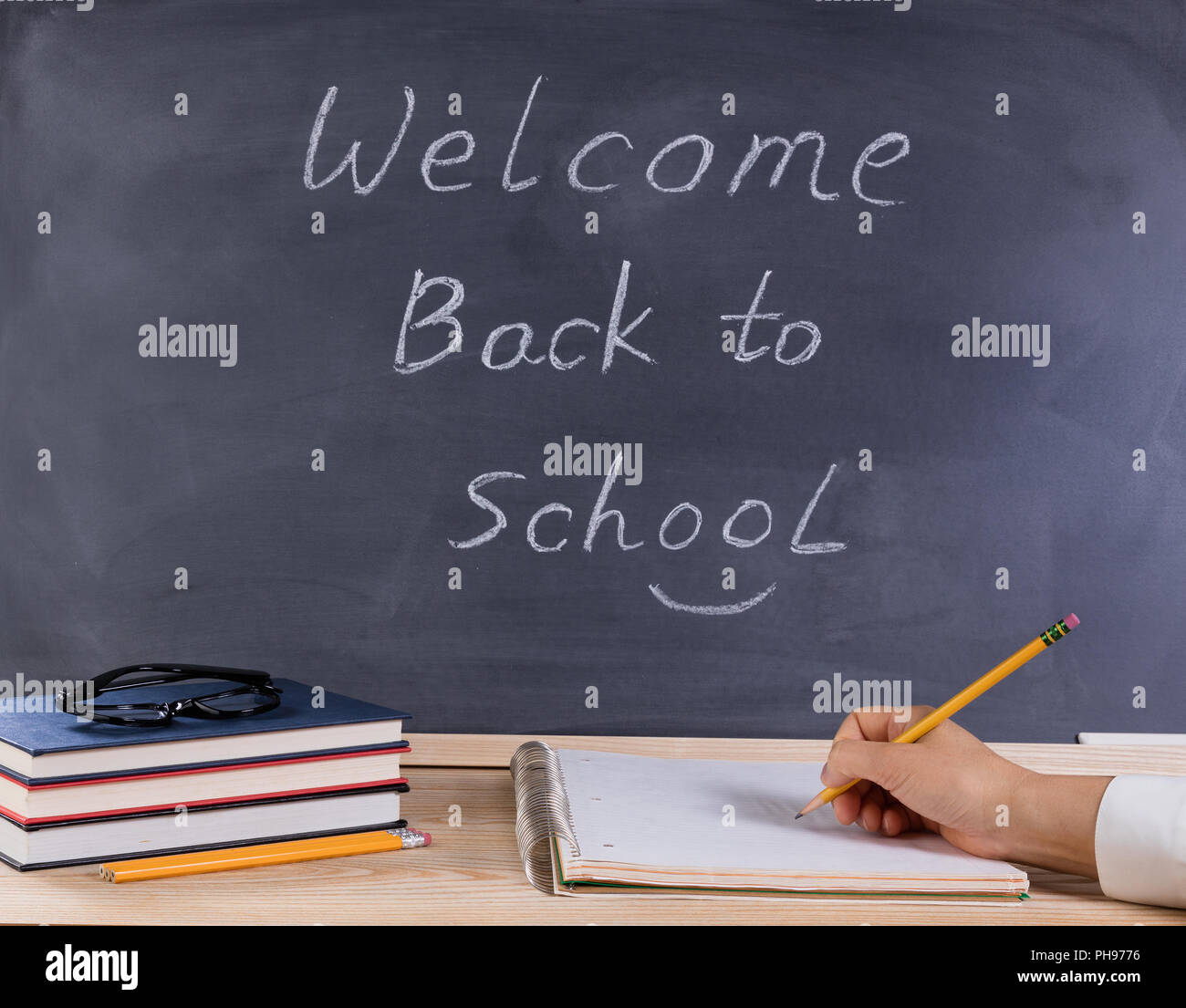 Preparing to write on notepad while in class Stock Photo