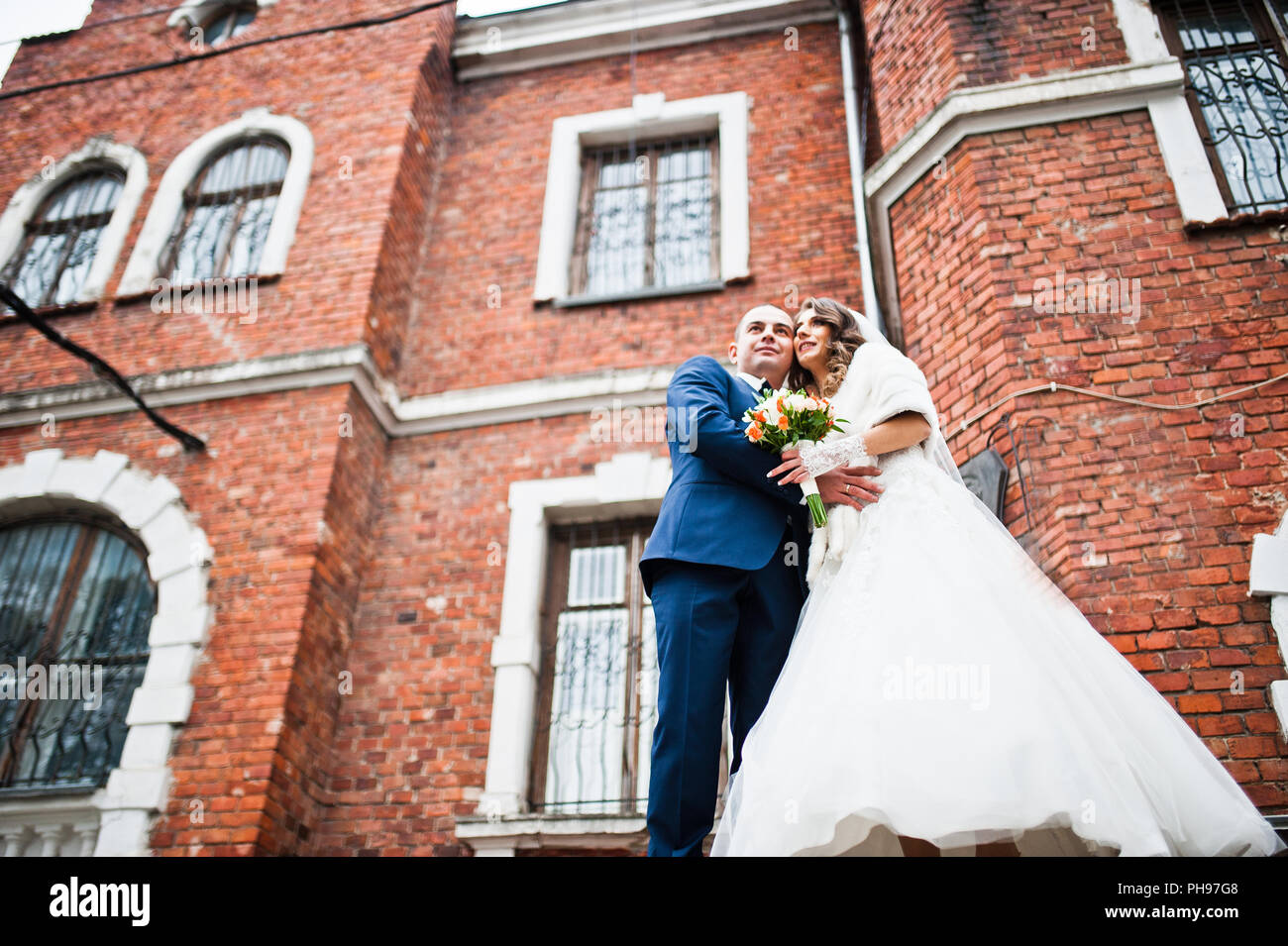 Wedding couple in love bacground old brick house Stock Photo