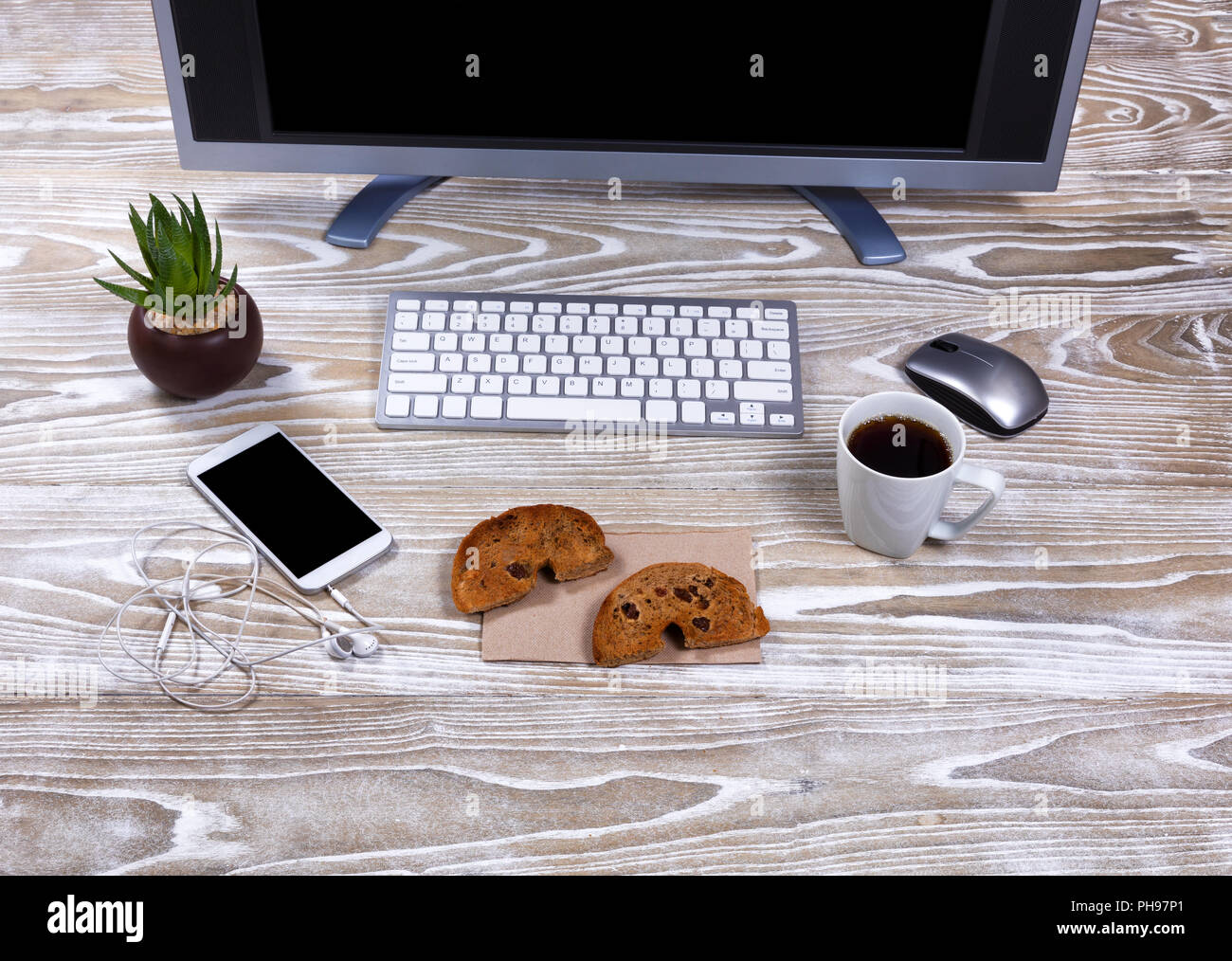 Toasted bagel and dark coffee on working desktop Stock Photo