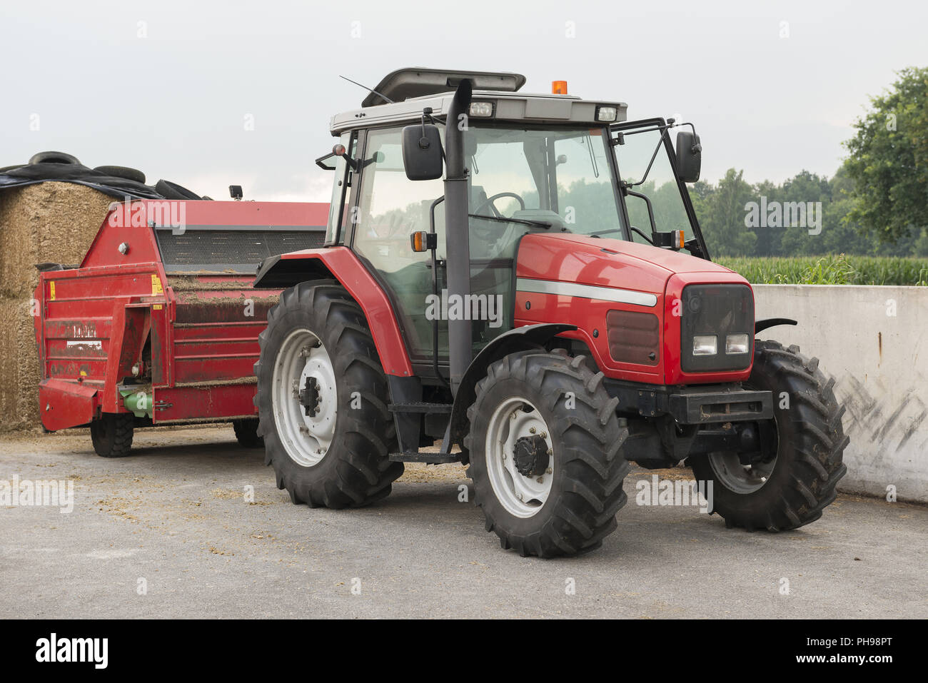 Red tractor with red cattle feed diffuser Stock Photo