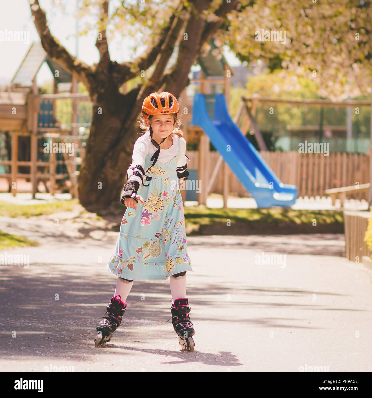 Young girl learning skating with inline skates Stock Photo Alamy