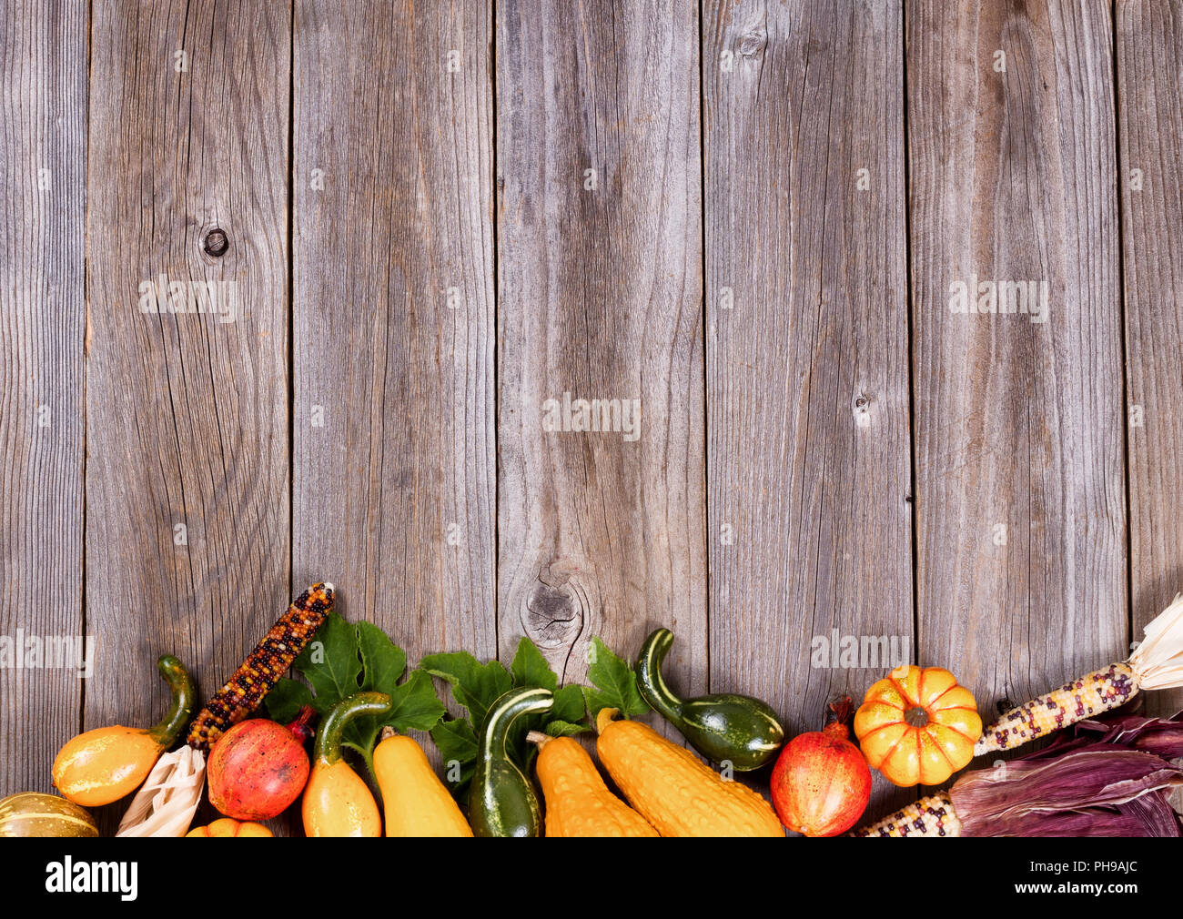 Mixed seasonal autumn vegetables on rustic wooden boards Stock Photo
