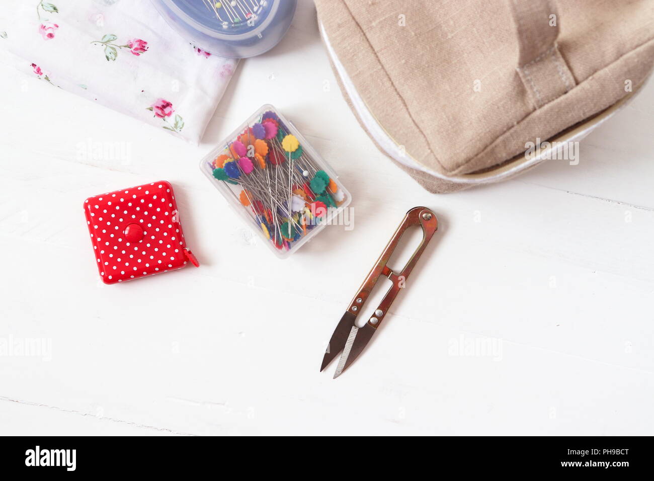 Sewing tools pins, cutter, measuring tape Stock Photo Alamy