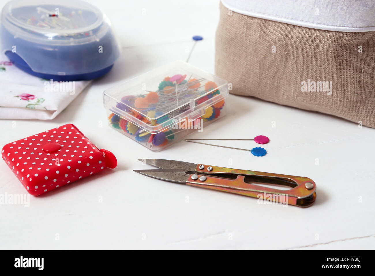 Sewing tools pins, cutter, measuring tape Stock Photo Alamy