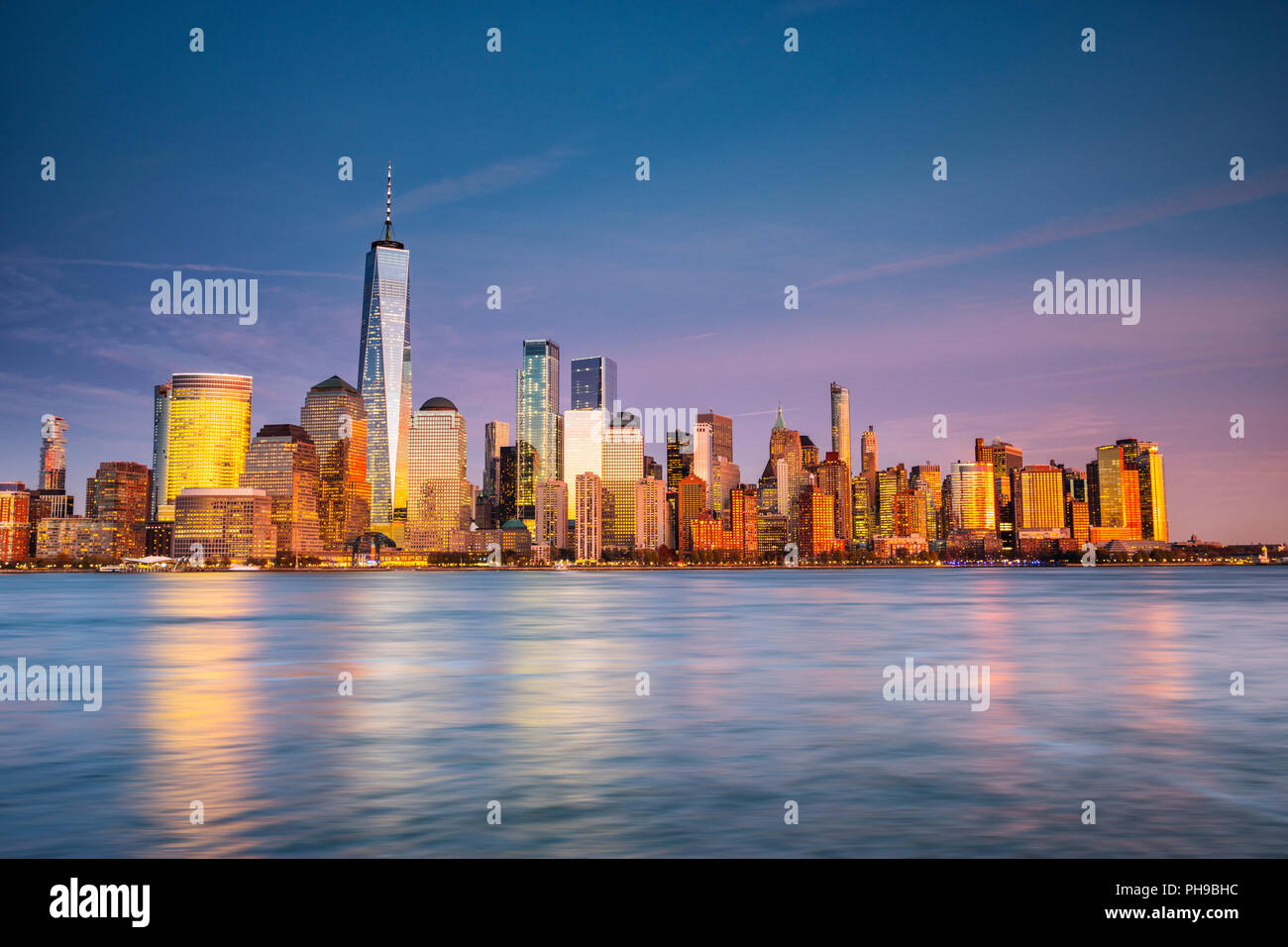 Lower Manhattan, Buildings reflections at sunset. View from New Jersey Stock Photo