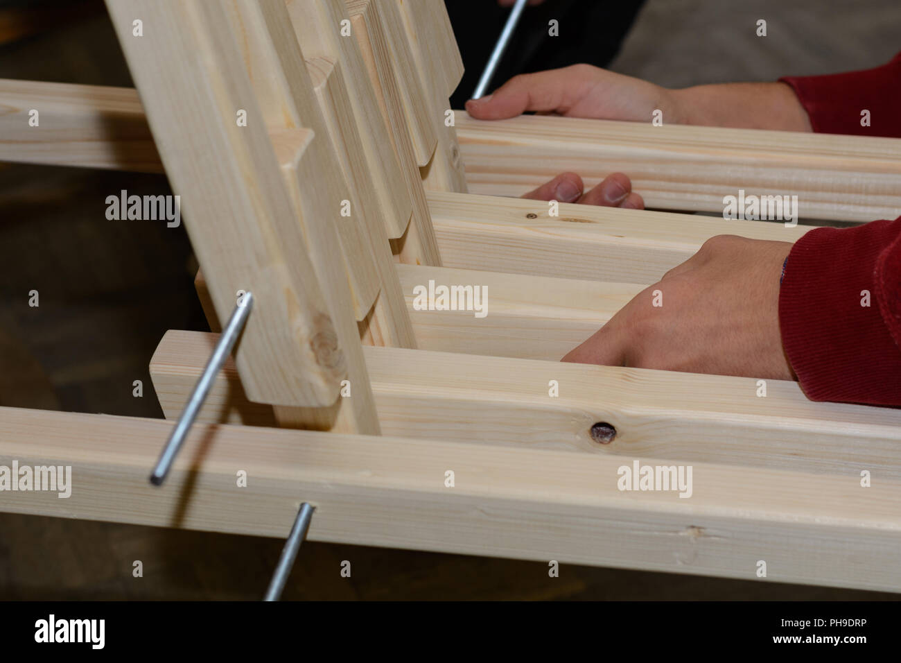 Carpenter producing rustic wooden armchair - close-up craftwork Stock Photo
