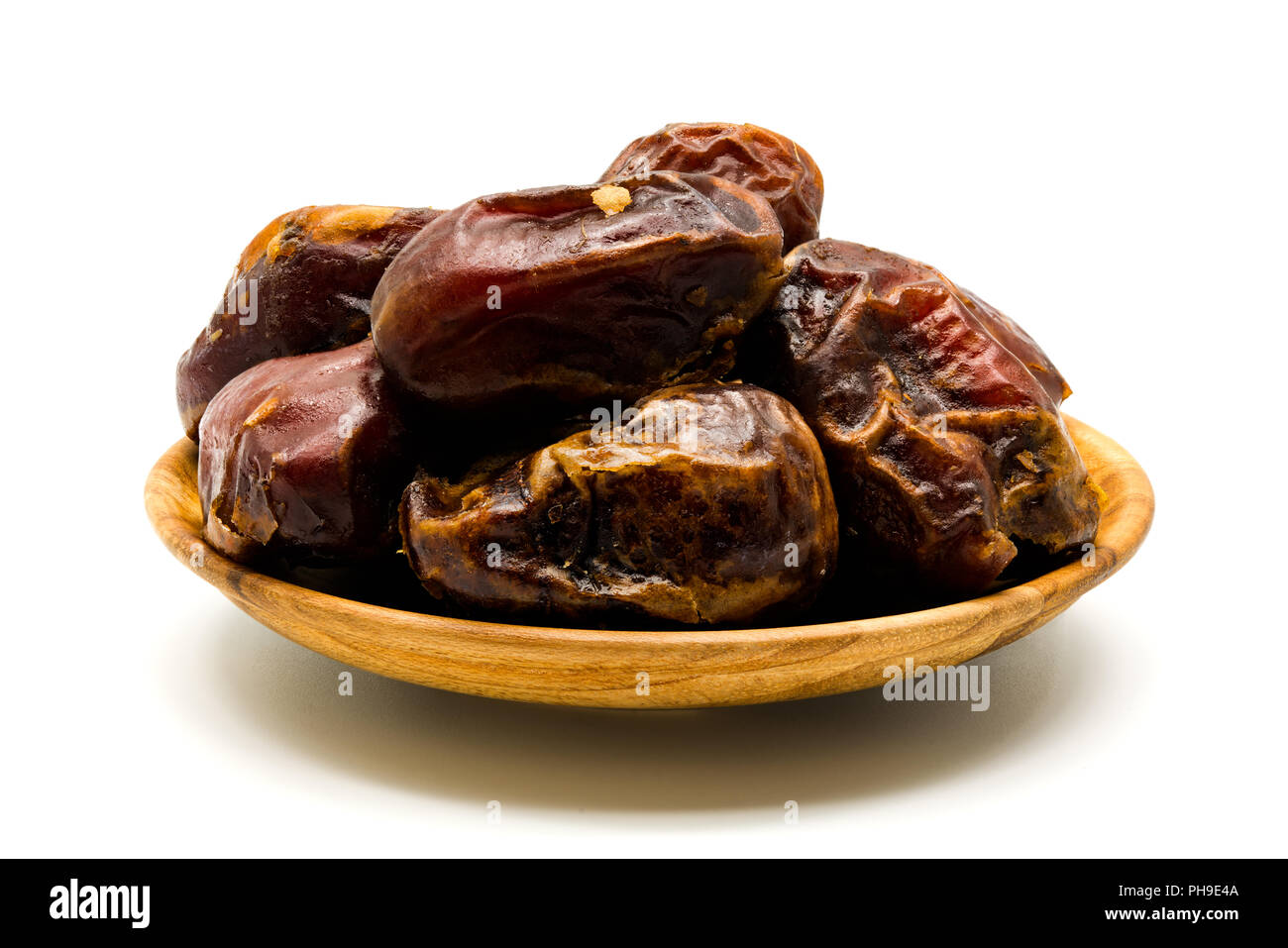 Dried dates in a wooden plate Stock Photo