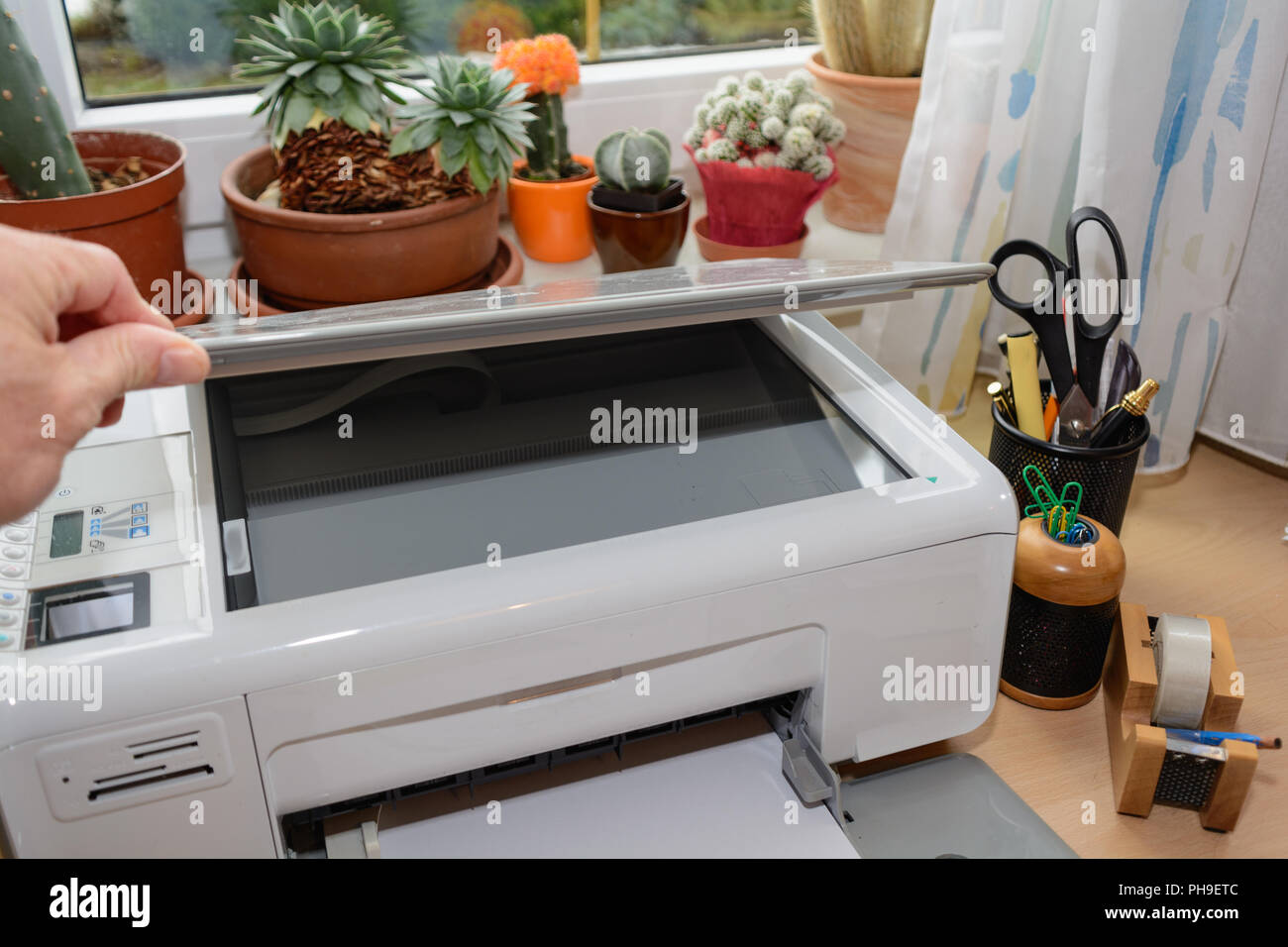 Inkjet printers and other office supplies are at the desk Stock Photo