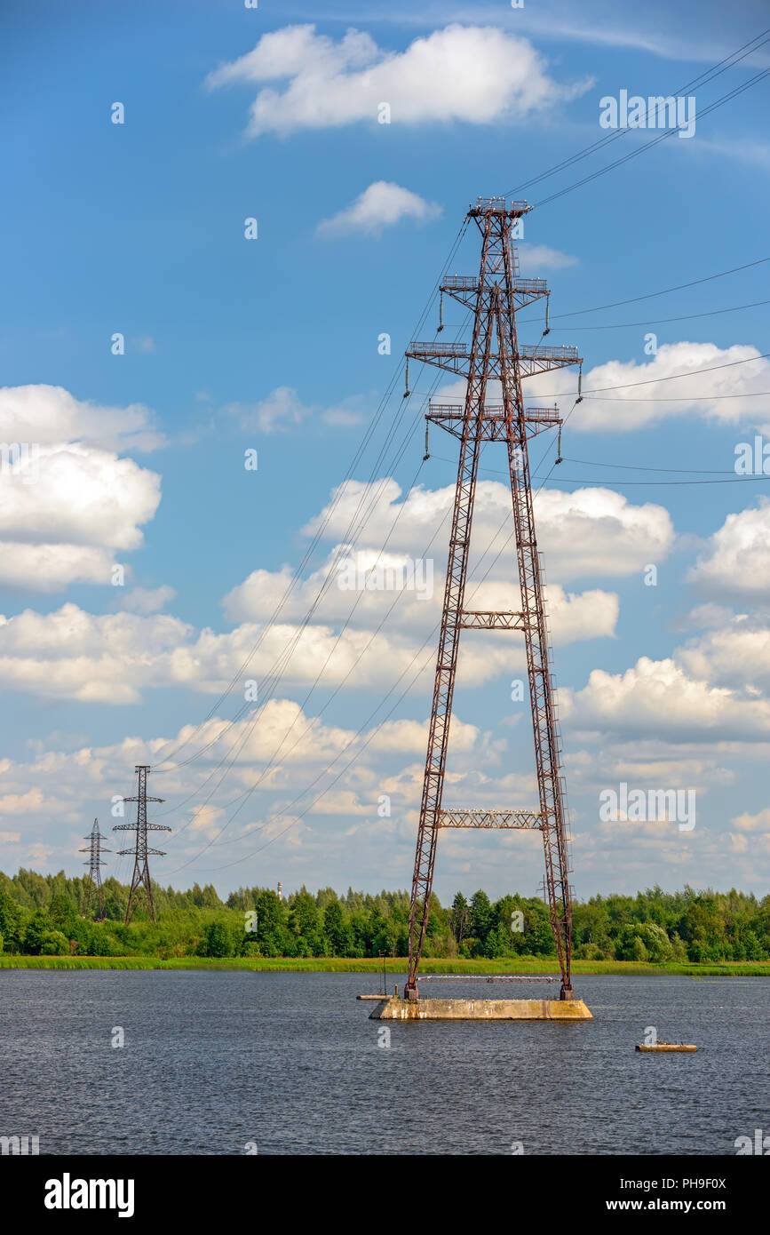 Power lines over river Stock Photo