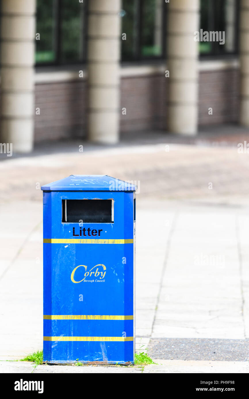 Blue litter bin outside the job centre on George street at the town centre of Corby, East Midlands, England. Stock Photo