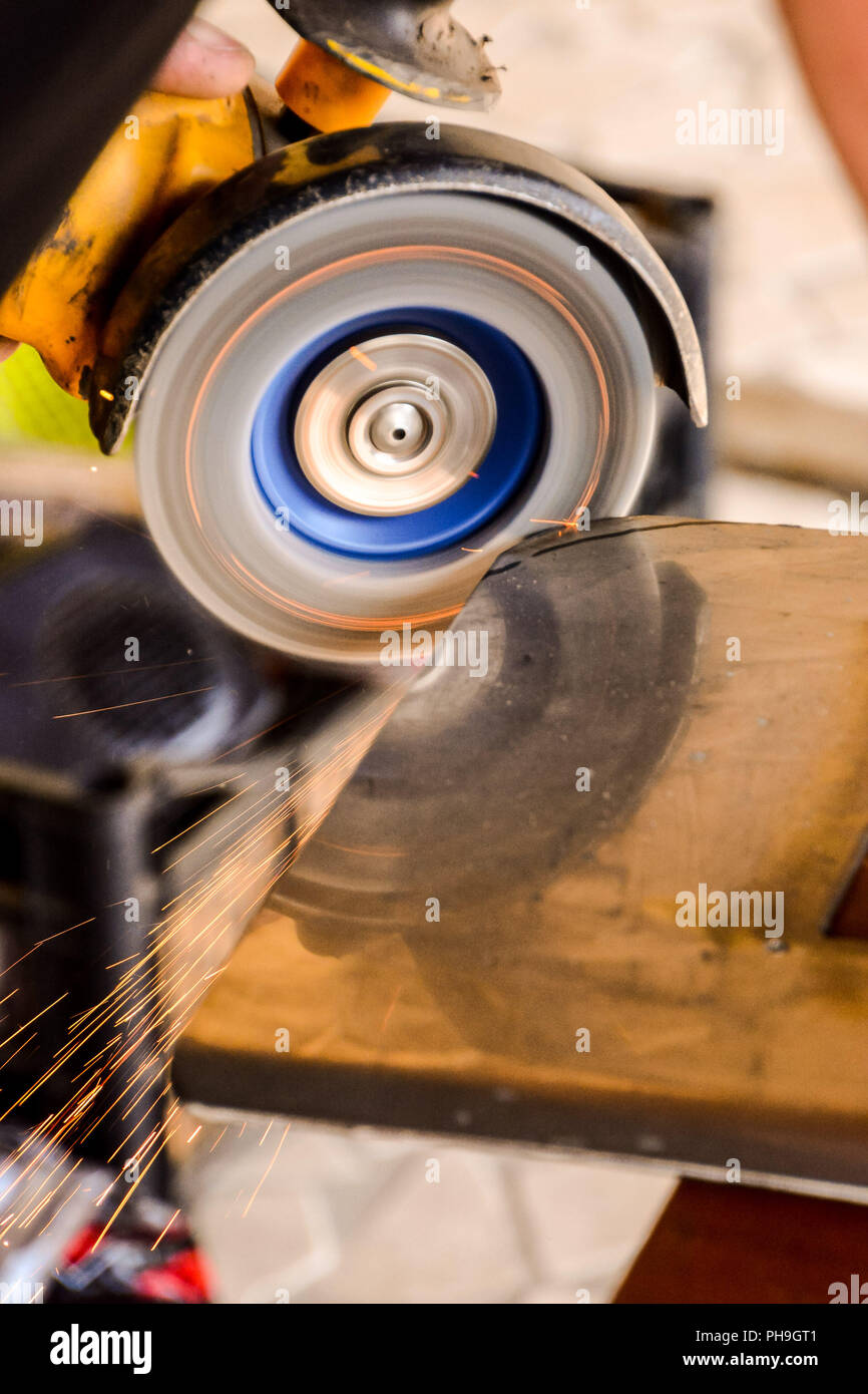 Cutting steel with angle grinder at car service Stock Photo Alamy
