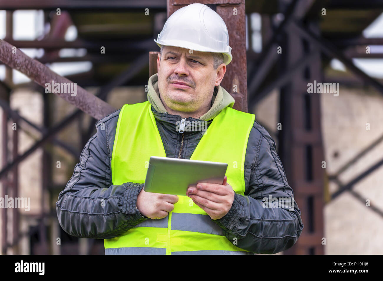 Engineer looking for information in tablet PC Stock Photo