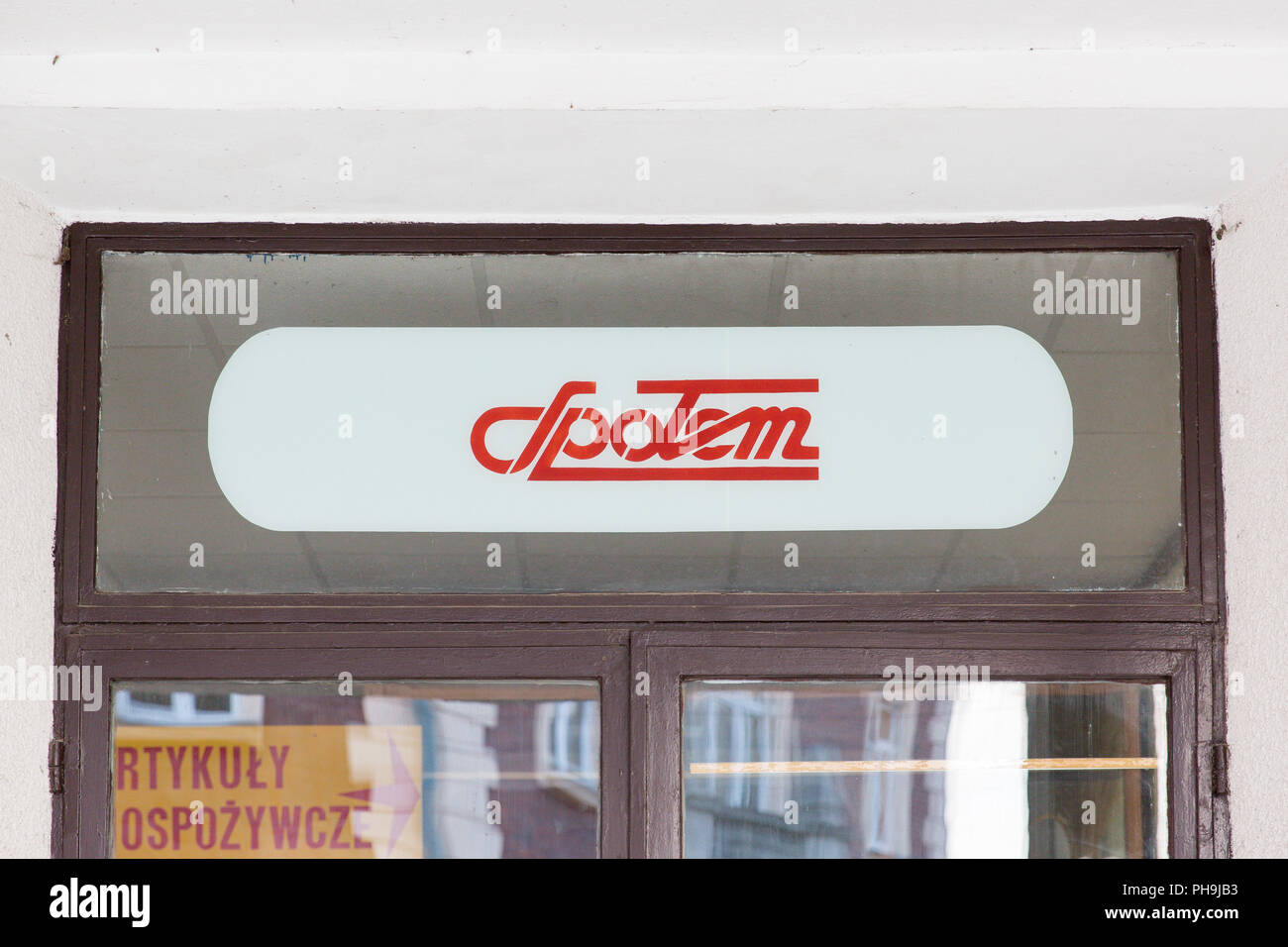 Spolem logo sign at the entrance door to the store is a Polish consumers' co-operative chain of local grocery stores founded in 1868 Stock Photo