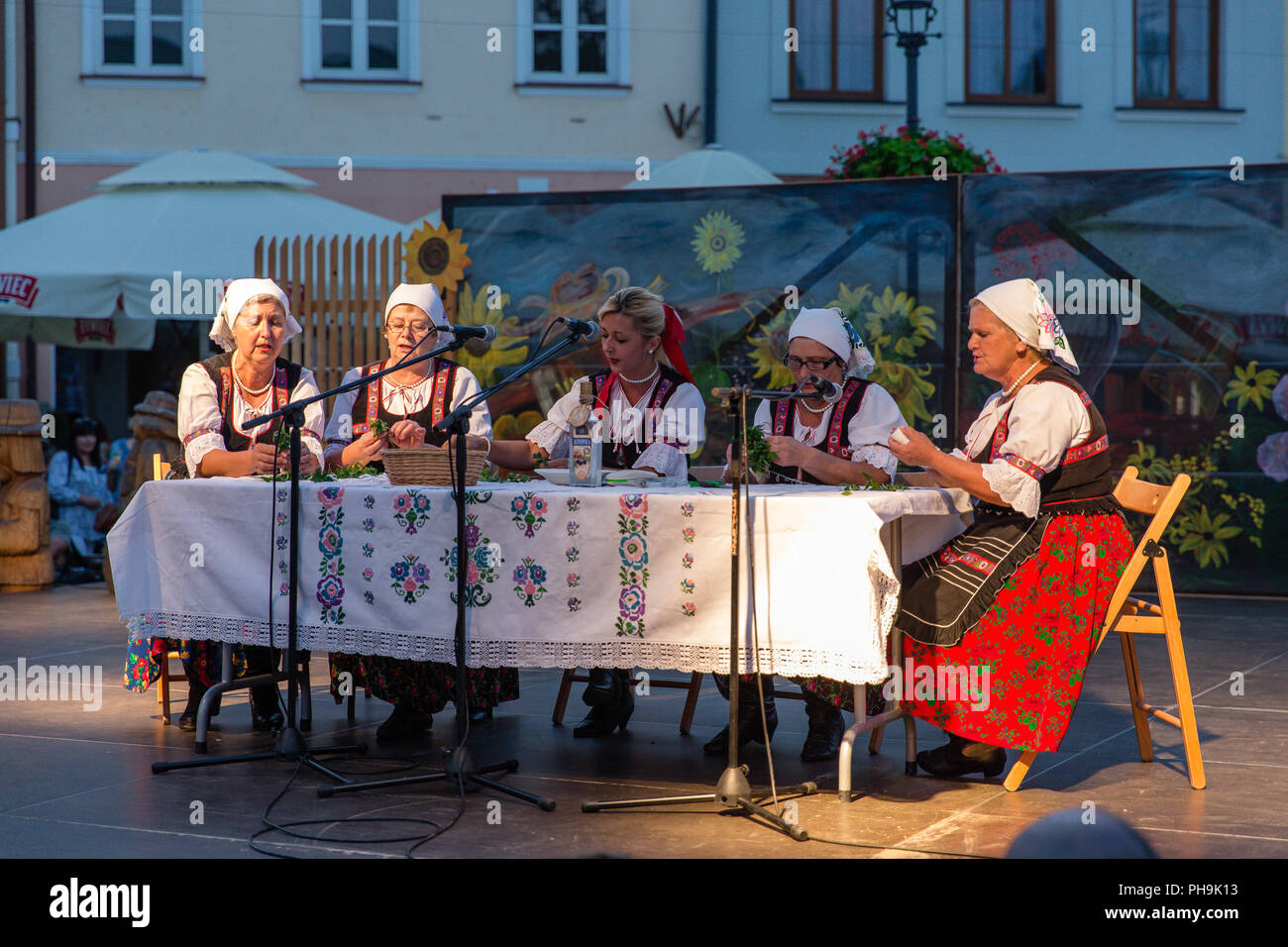 Hungarian Magyar Women dress in traditional Folk costumes singing on stage at the Carpathian Climates international cultural event in Krosno, Poland Stock Photo