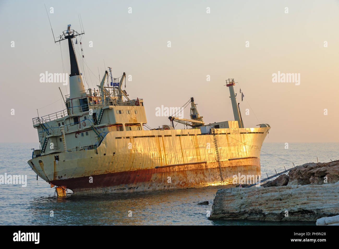 Ship aground near rocky coast Stock Photo