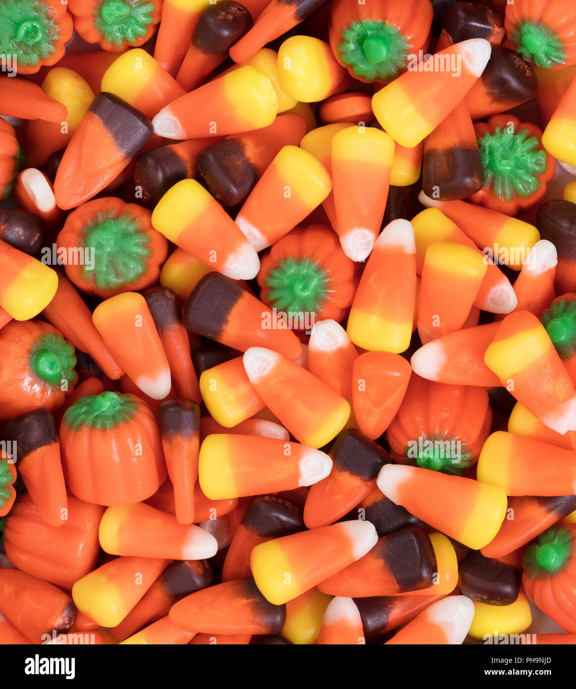 Filled frame of autumn holiday candy corn and pumpkin shapes Stock Photo