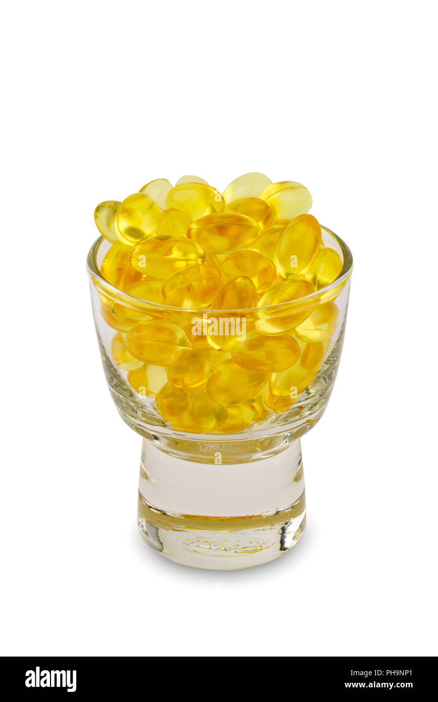 Capsule of medicine in a small glass Stock Photo