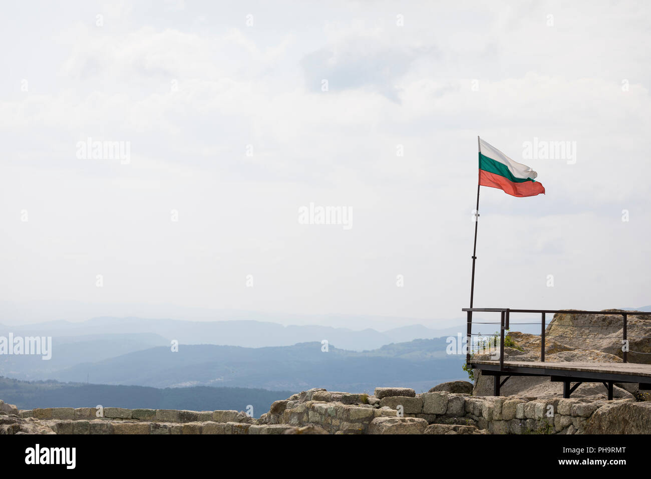 Bulgarian flag waving at Perperikon, landscape with mountains and forest, Bulgaria Stock Photo