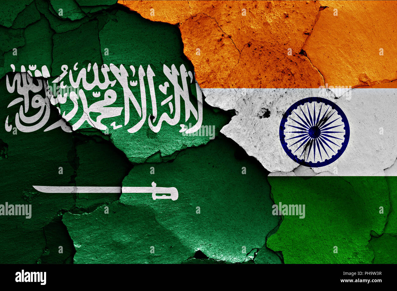 flags of Saudi Arabia and India painted on cracked wall Stock Photo