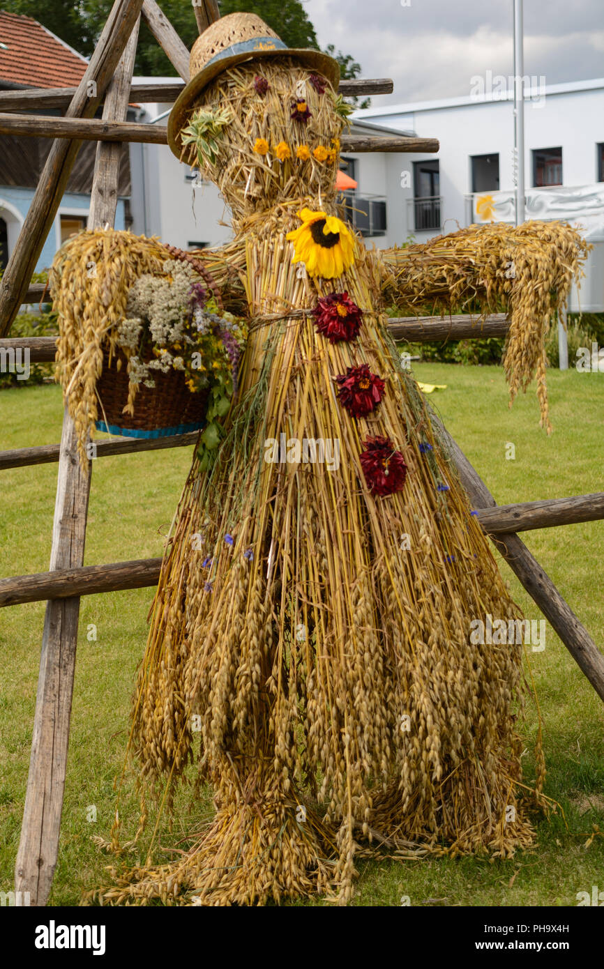 Bright colorful and creative scarecrows as autumn messenger Stock Photo