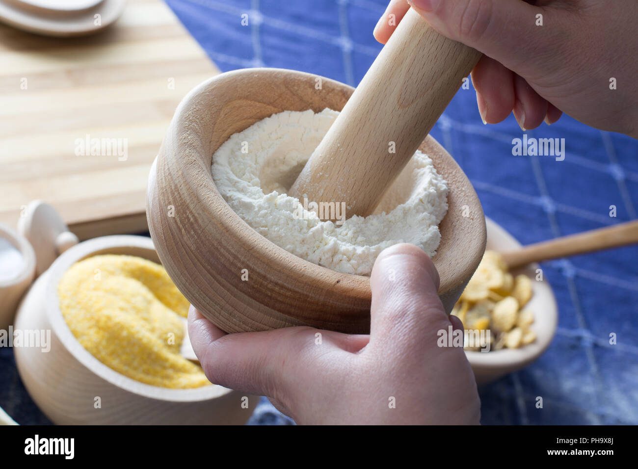 Female hand holding mortar and pestle with wheat flour Stock Photo Alamy