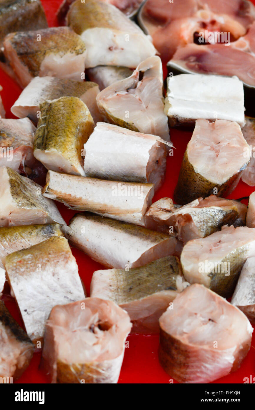 Fish hake sliced and chopped and prepared to be baked Stock Photo