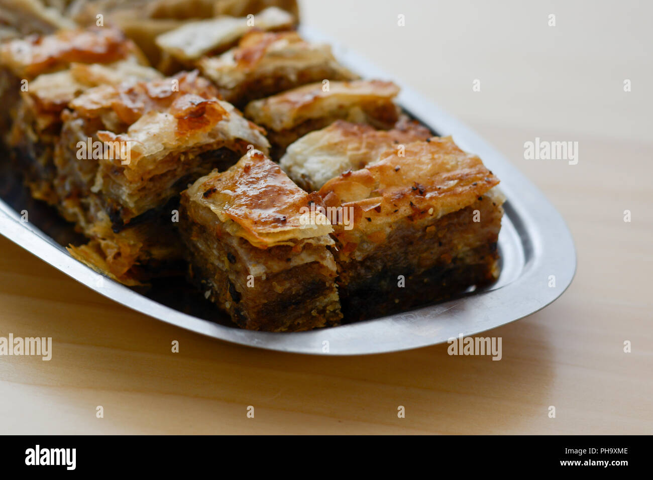 Traditional serbian cake baklava arranged on metal plate. Stock Photo