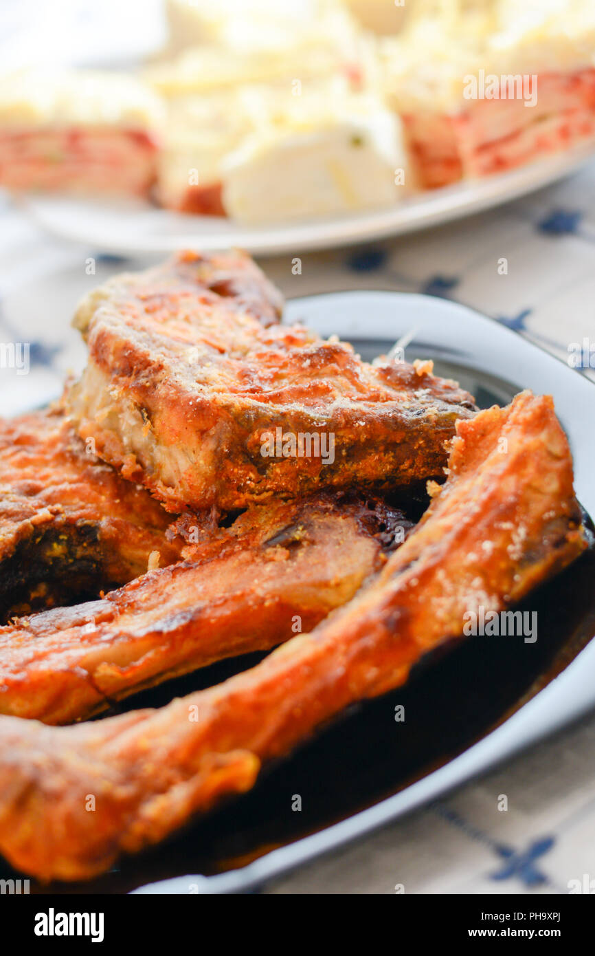 Fish stakes on plate served on home table Stock Photo