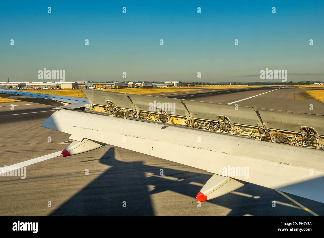 Close up view of the air brakes fully open on the wing of a passenger jet  after landing Stock Photo - Alamy