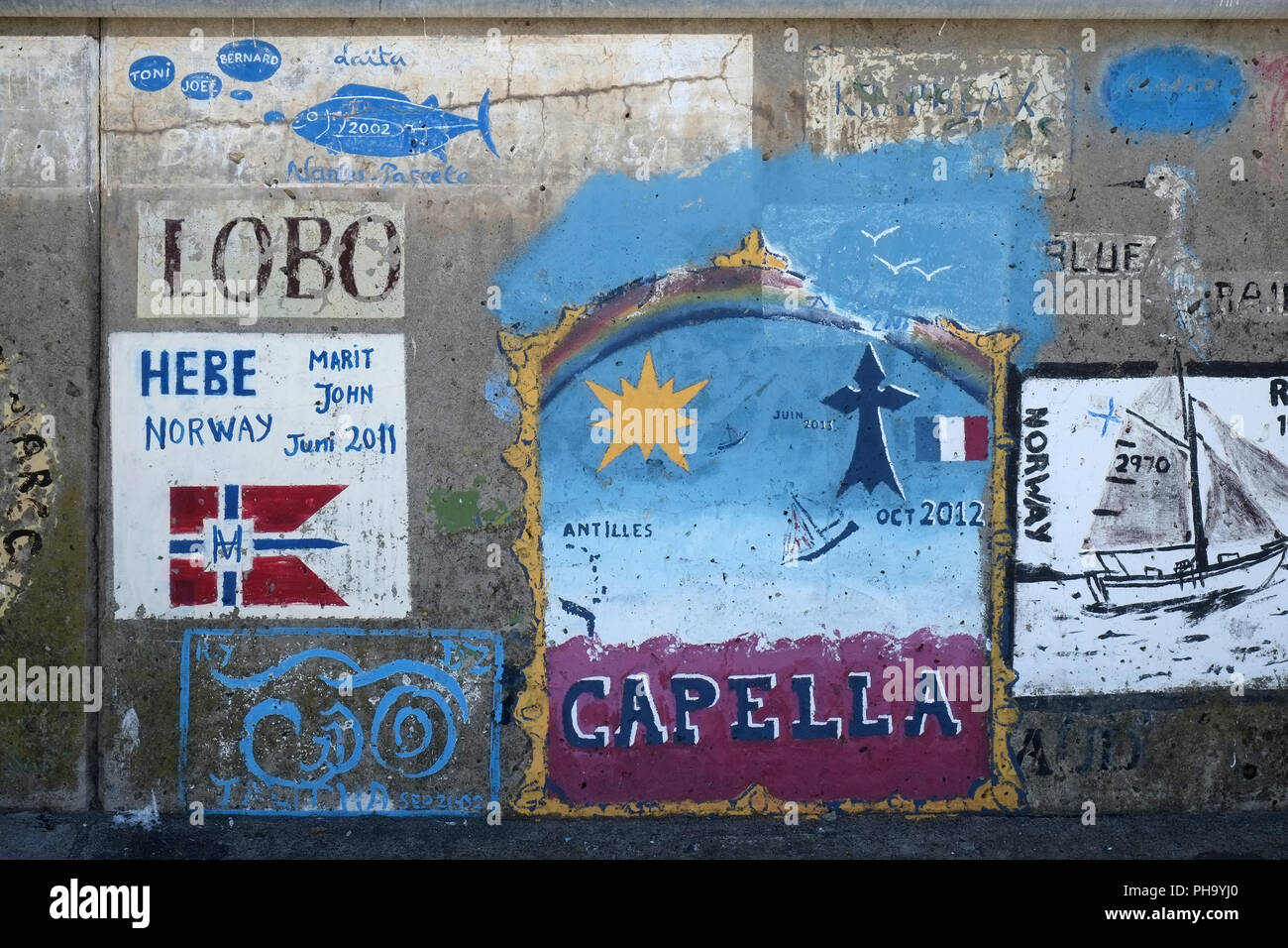 Logos of sailors on the harbour wall of Funchal Stock Photo
