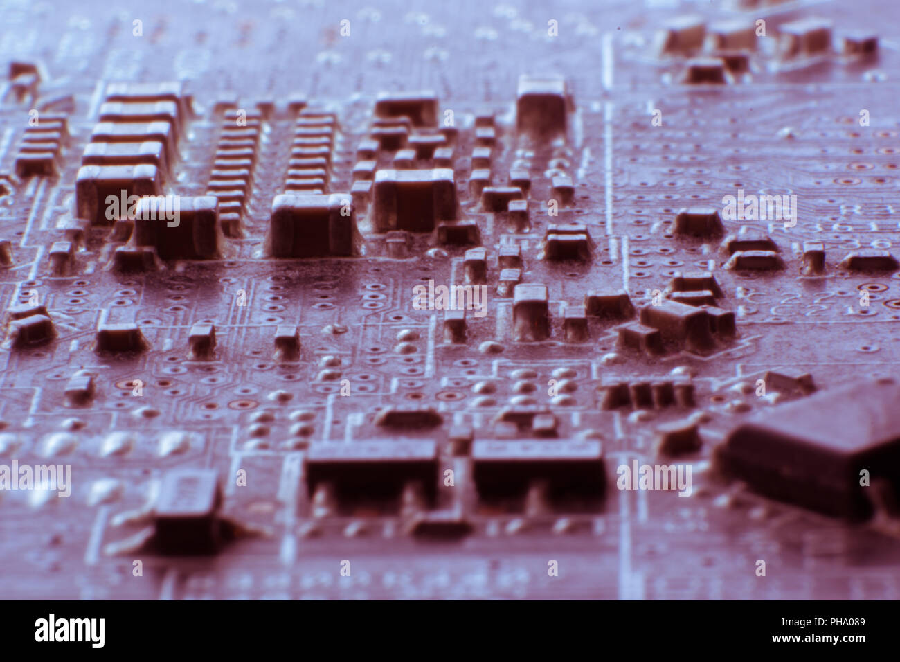 Surface-mount dusty smd components on used electronic circuit board. Stock Photo