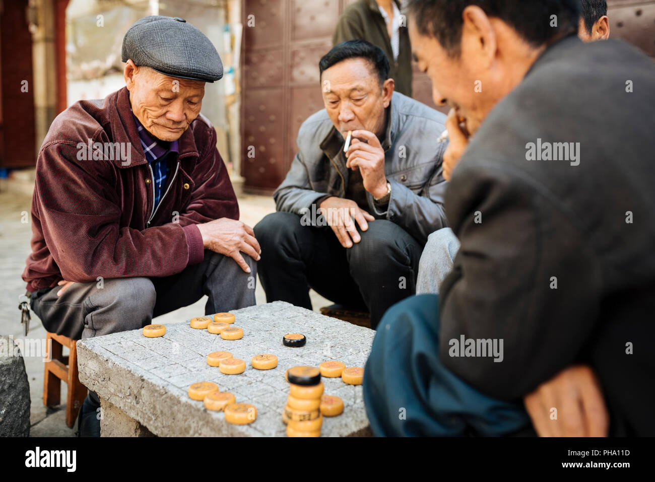 Men playing traditional game of Xiangqi (Chinese Chess), Dali, Yunnan Province, China, Asia Stock Photo