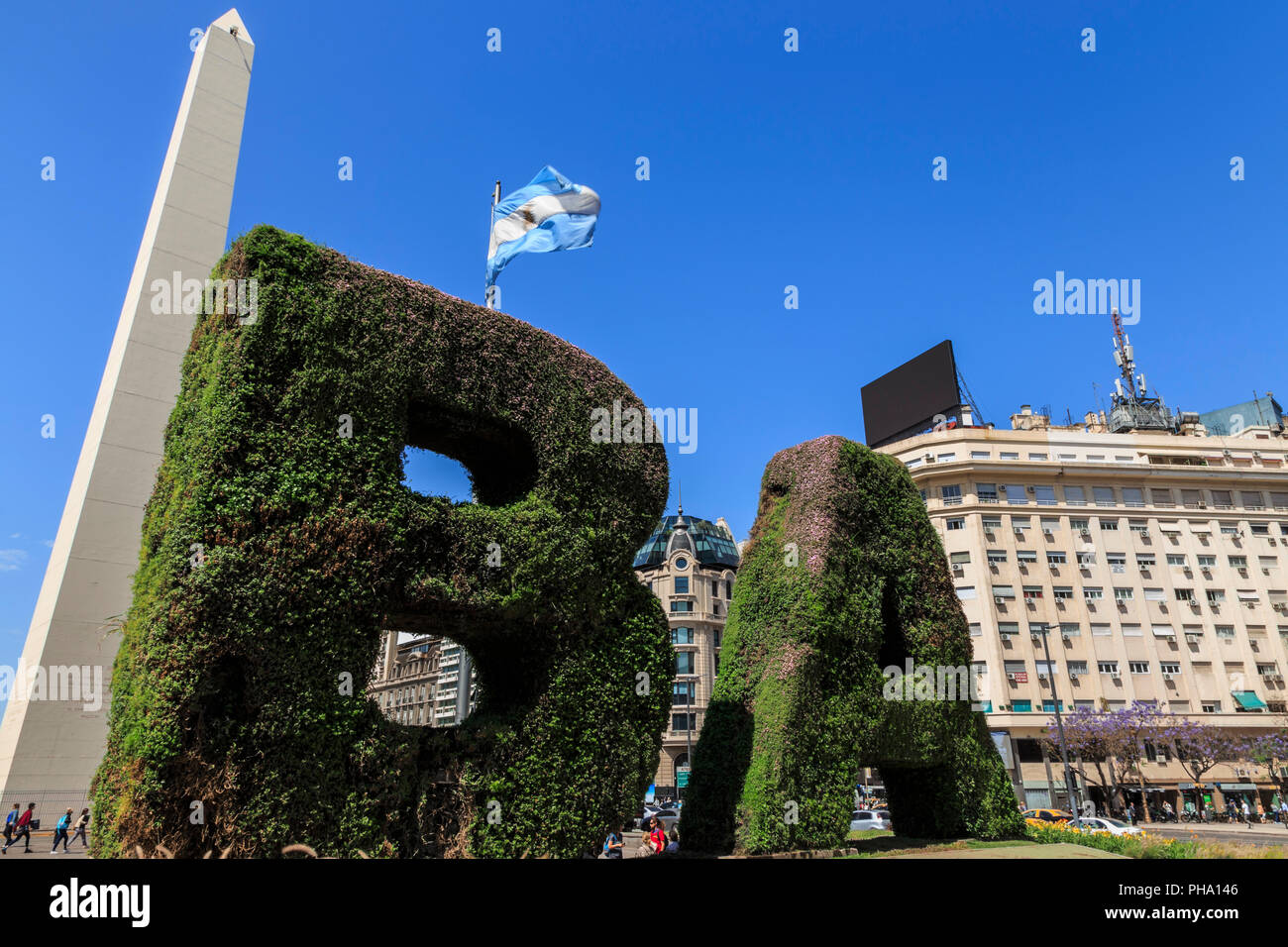 BA in topiary, Obelisco iconic monument and flag, Plaza de la Republica, Congreso and Tribunales, Buenos Aires, Argentina, South America Stock Photo
