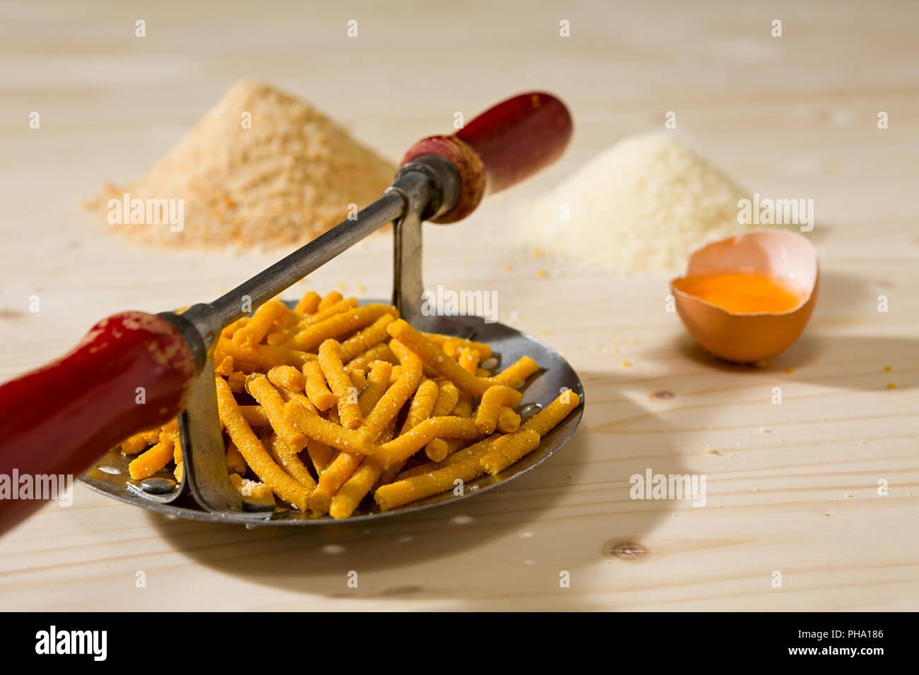 Passatelli original Italian pasta on its tool Stock Photo Alamy