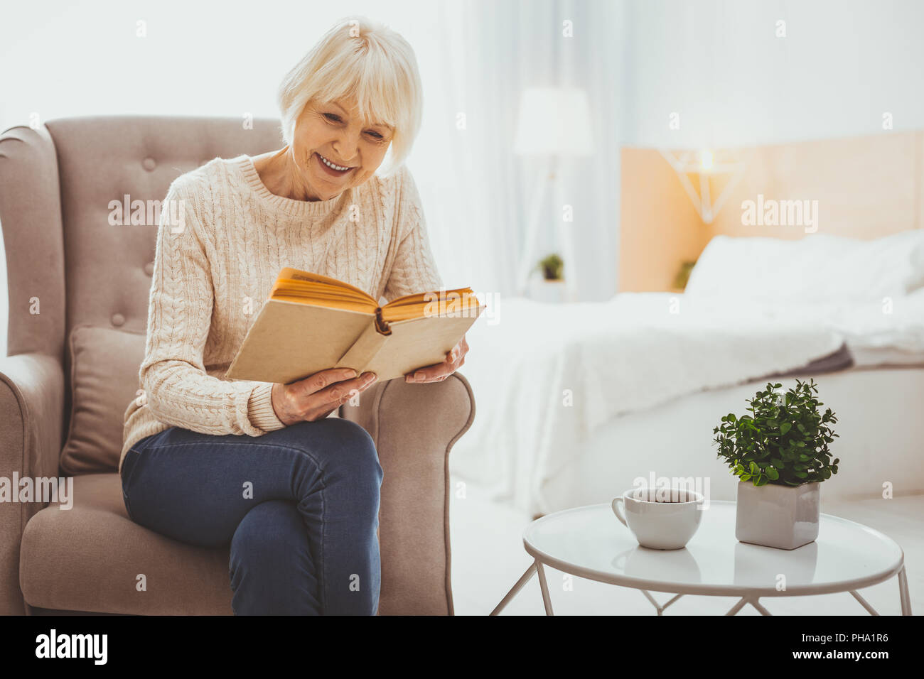 Pleased mature woman reading hi-res stock photography and images - Alamy