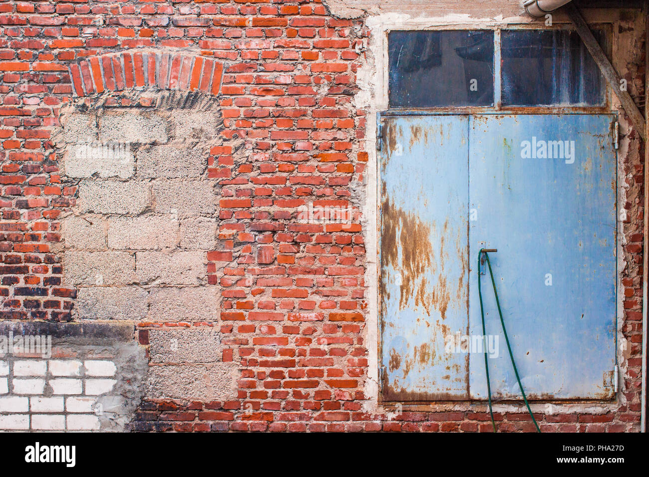 Door in brickwall of old industrial building Stock Photo