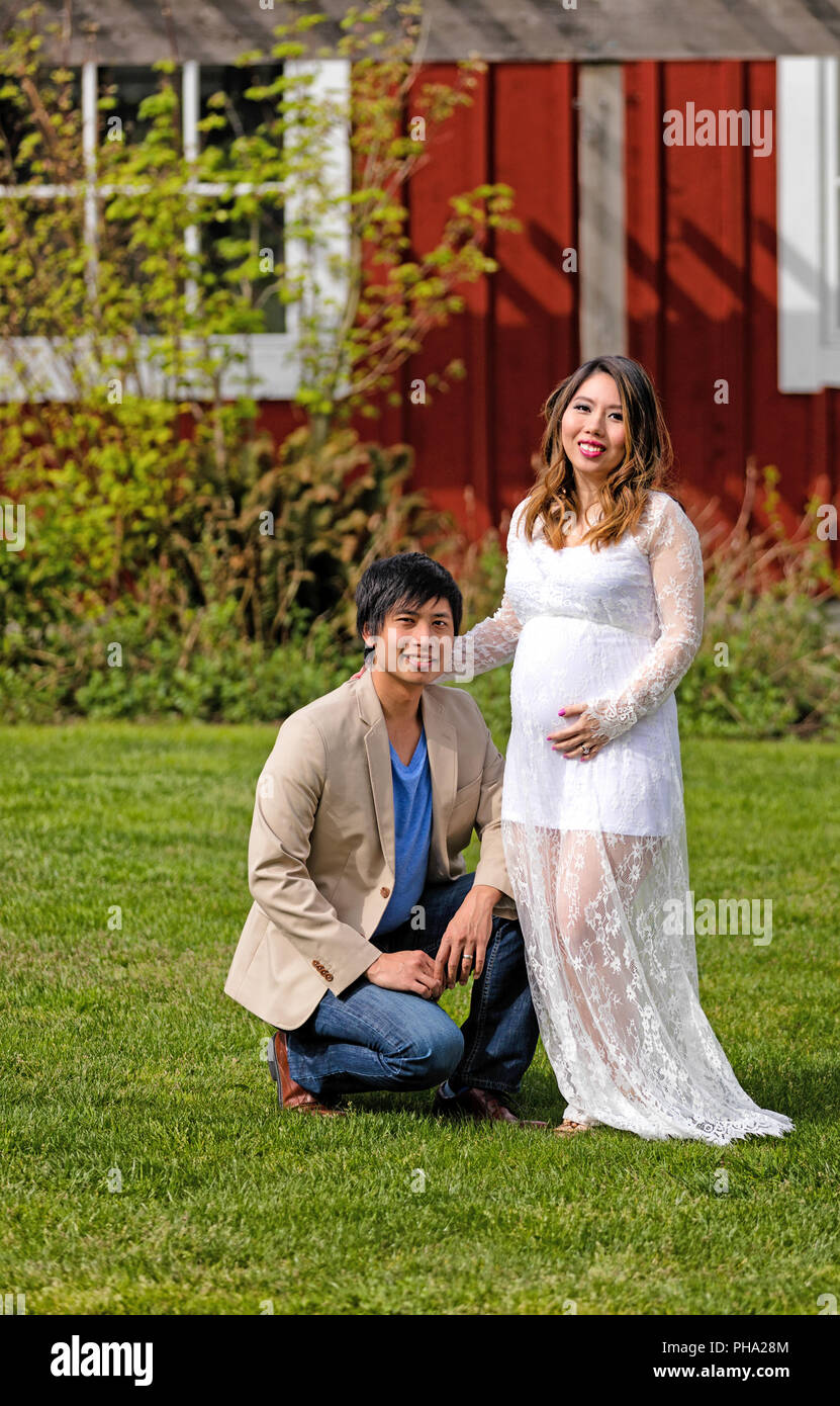 Expecting mom and dad enjoying the day outdoors Stock Photo