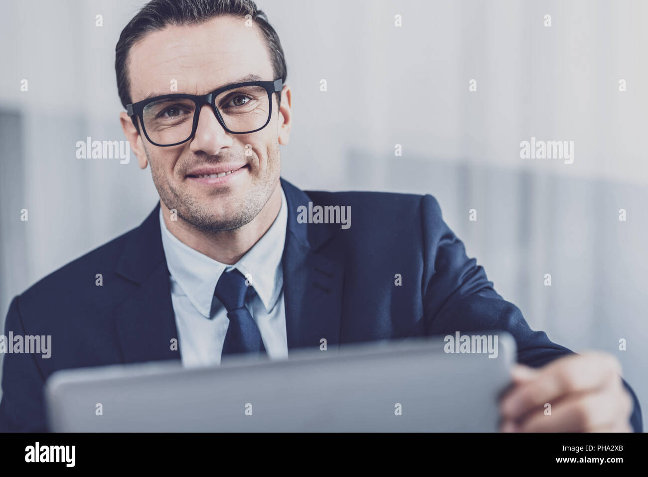 Cheerful entrepreneur opening a laptop Stock Photo