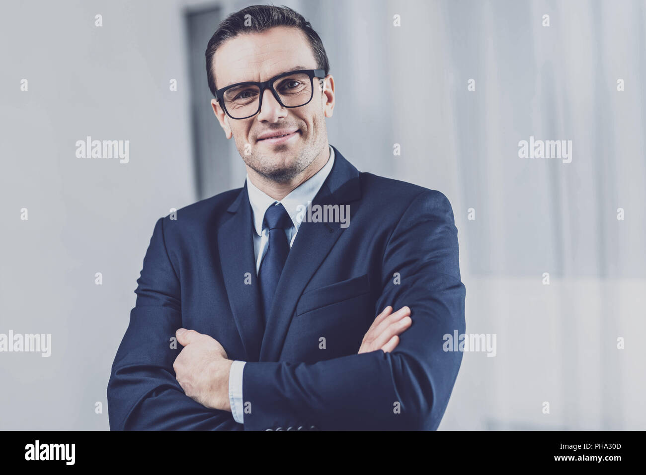 Ambitious businessman folding his arms on his chest Stock Photo