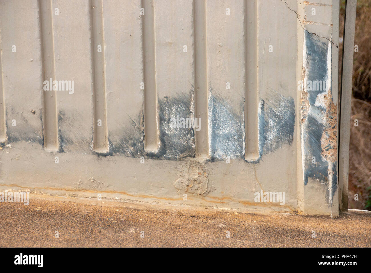 A concrete wall on a bridge  that was been damaged by an odject passing by or crashing into it Stock Photo