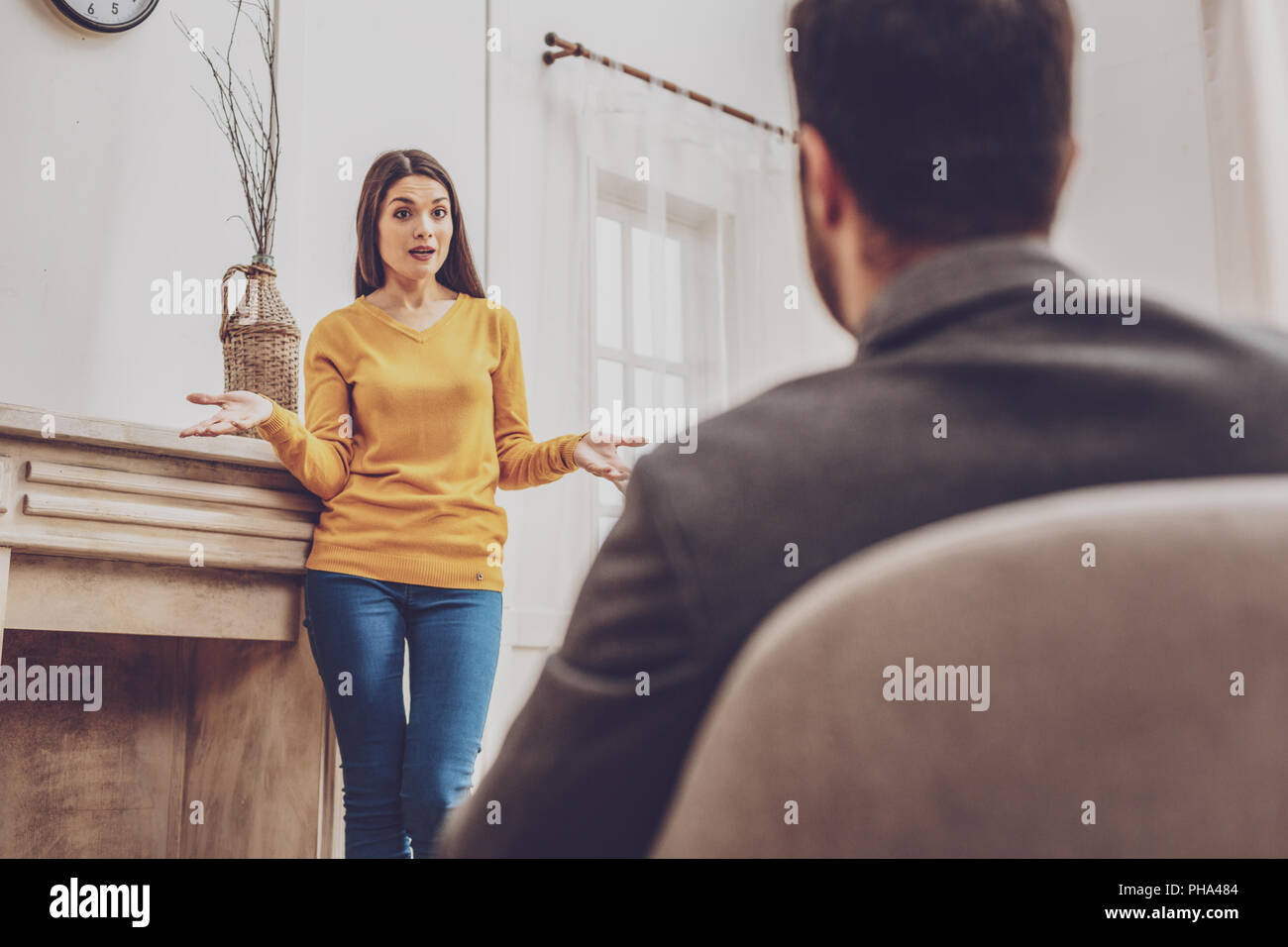 Surprised young woman talking to her man Stock Photo - Alamy