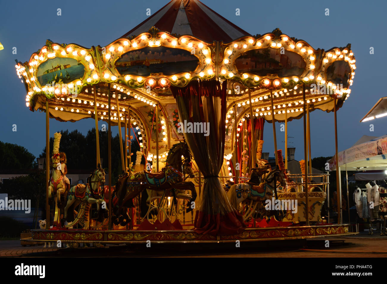 Illuminated ring game in the evening - carrousel Stock Photo