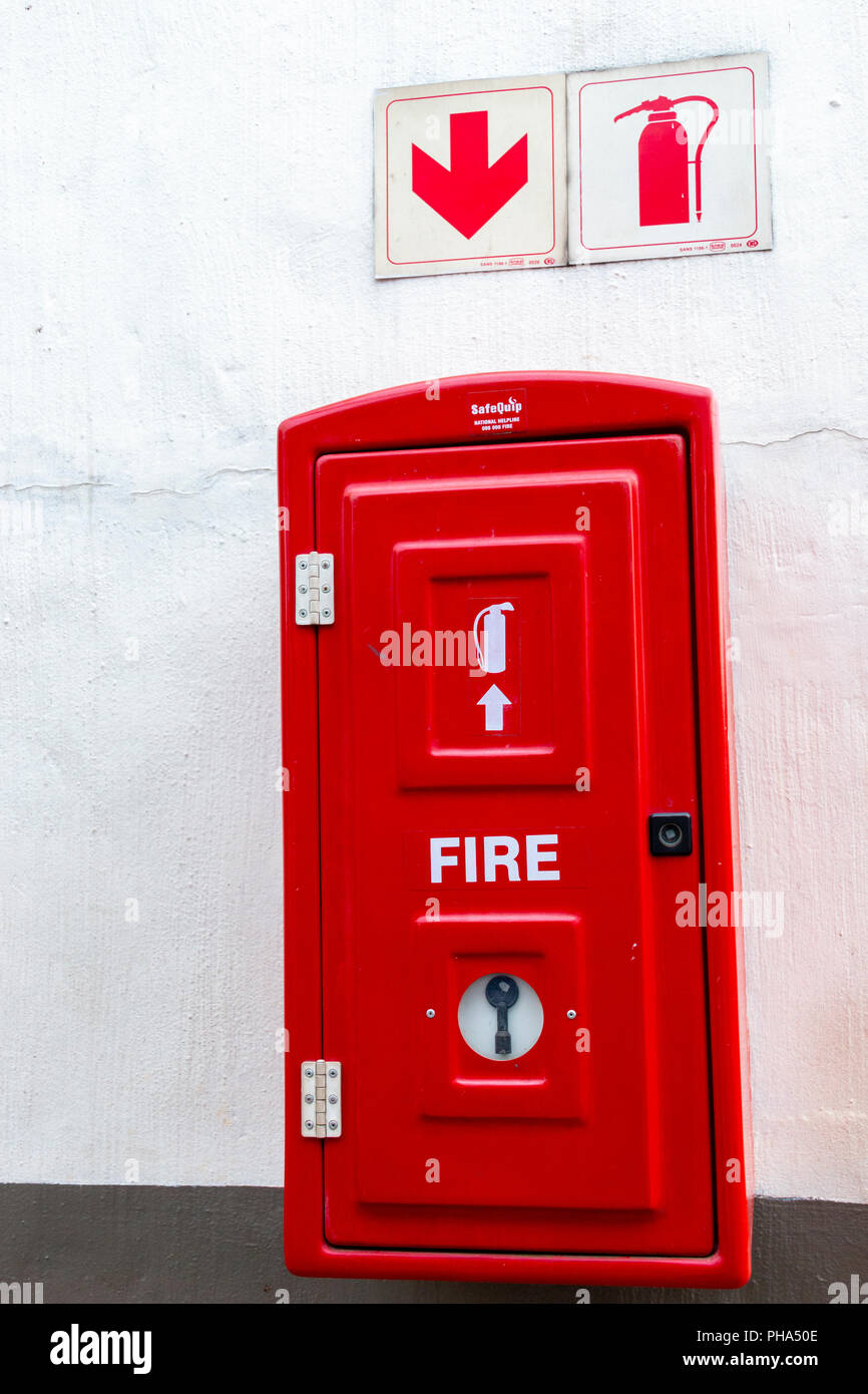A Close up view of a red fire extinguishes box incase of a fire Stock Photo
