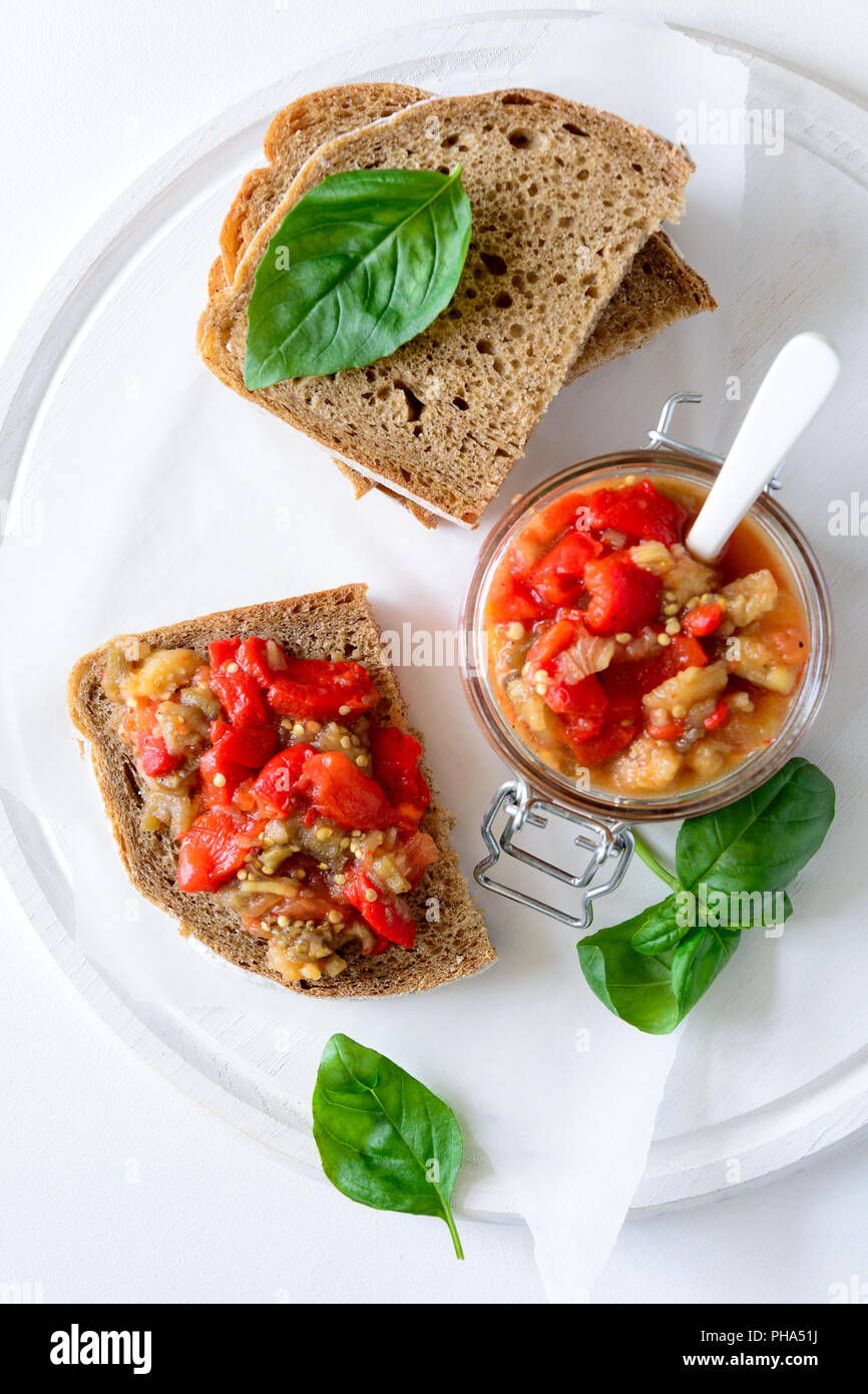 Rye bread toasts and glass jar with eggplant caviar. Vegetable appetizer or antipasti. Healthy
