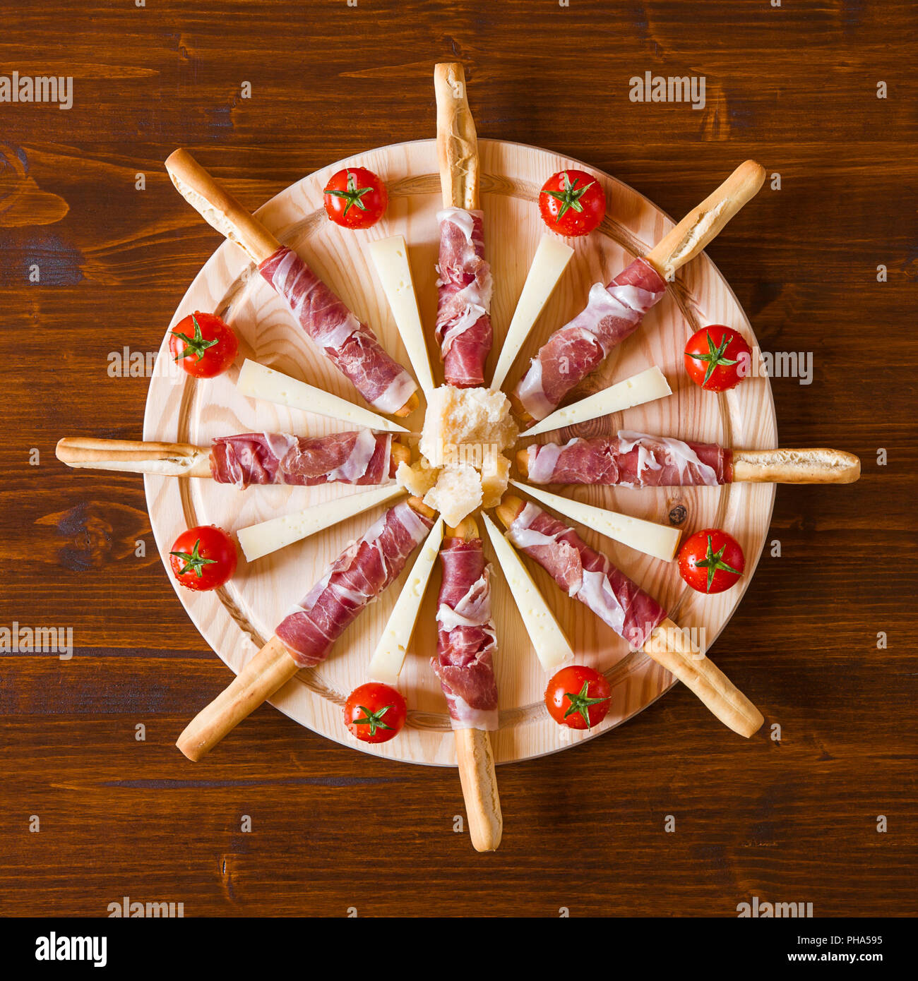 Chopping board with ham cheese and cherry tomatoes Stock Photo - Alamy