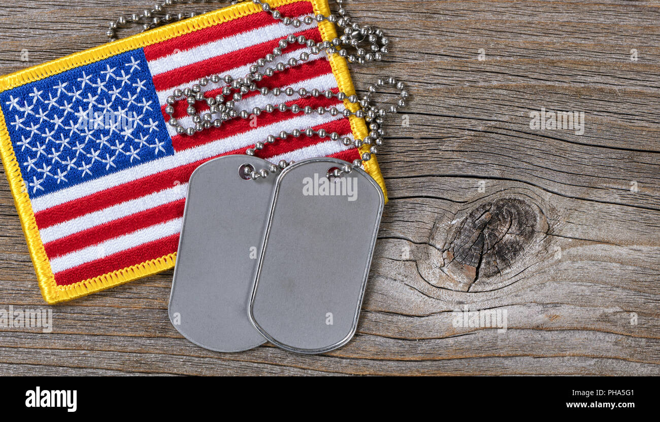 American flag with dog tags on rustic wood Stock Photo